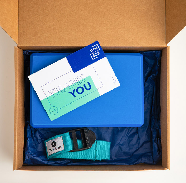 Gym In A Box package featuring a yoga block, a turquoise strap, and a thank you card, by Pelion-villas.com.