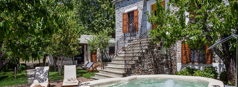 Traditional stone house with jacuzzi and green surroundings at Pelion Esties in Pelion