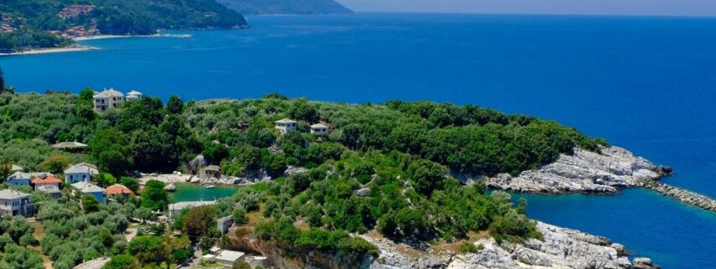 Rocky coves with turquoise water and forested hills along the Pelion coastline in mainland Greece.