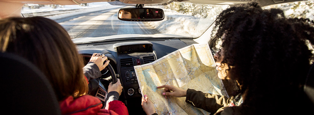 Aerial view of a peaceful coastal village in Pelion, Greece, with a beach, pier, and surrounding hills – perfect vacation spot