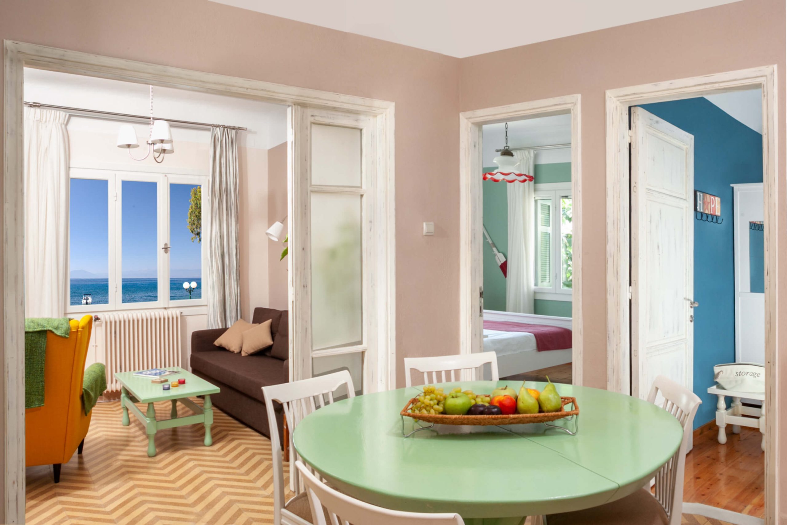 Spacious living and dining area with large windows offering sea views, at Avgi by the Sea apartment, Pelion Villas.