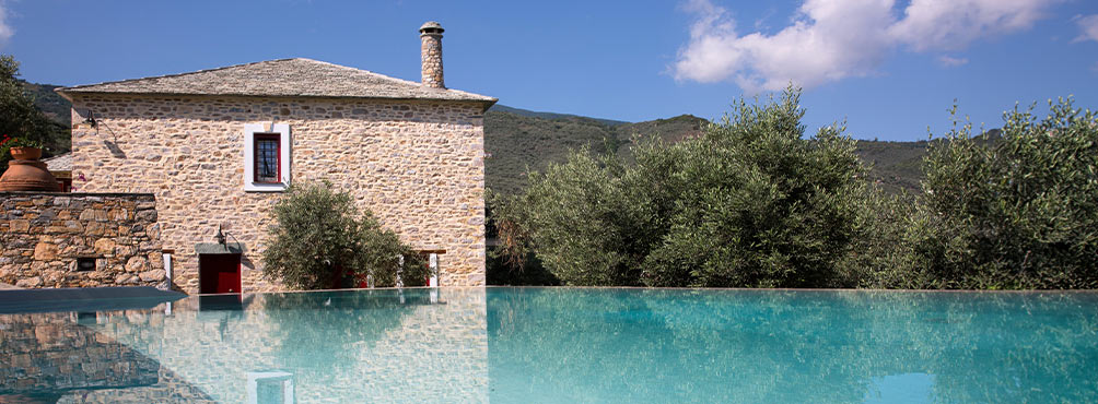 Traditional stone villa with a private pool and olive trees, set in a peaceful mountain location