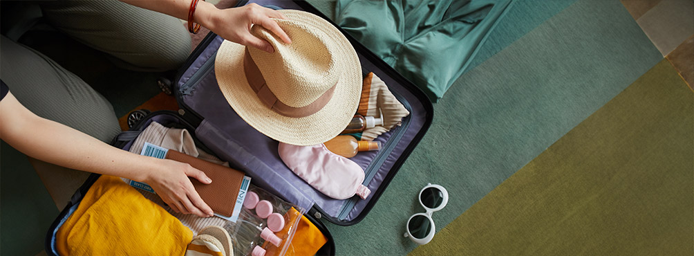 Open suitcase with holiday items ready for a comfortable escape to Pelion Esties